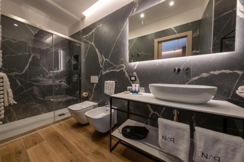 a bathroom with a sink and a toilet at NAP Luxury Guest House Municipio in Naples