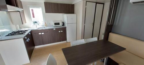 a small kitchen with a sink and a refrigerator at Triocamp Praha in Prague