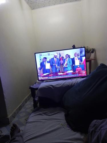 a laptop computer sitting on top of a bed at Pastor Anne homes in Nairobi