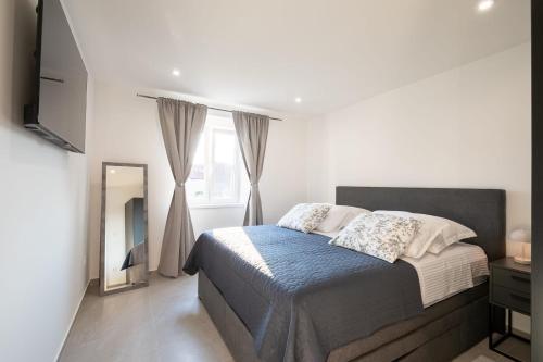 Postel nebo postele na pokoji v ubytování Apartment Centar 2