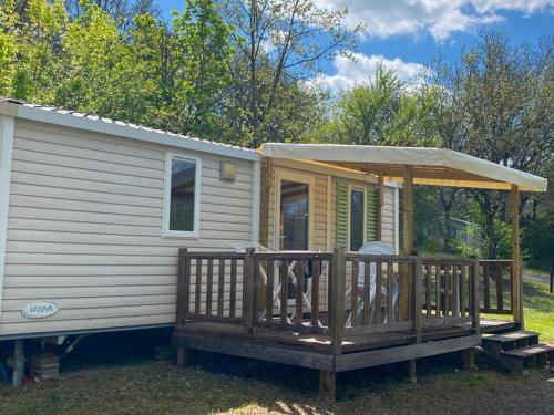 a mobile home with a porch and a gazebo at Camping maeva Respire de La Croze in Châtel-Guyon