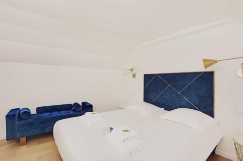 une chambre avec un grand lit blanc avec une tête de lit bleue dans l'établissement Luxurious apartment - 3BR-6P - Nation, à Paris