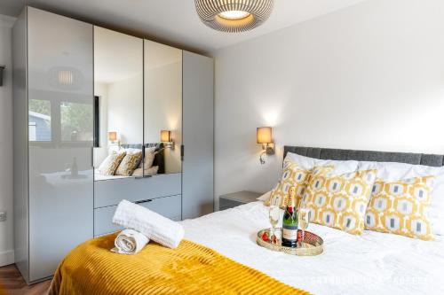 a bedroom with a bed with a yellow blanket at Harbour Haven by Grandeur Property in Poole