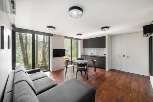 a living room with a couch and a table at Juodasis Gintaras in Palanga