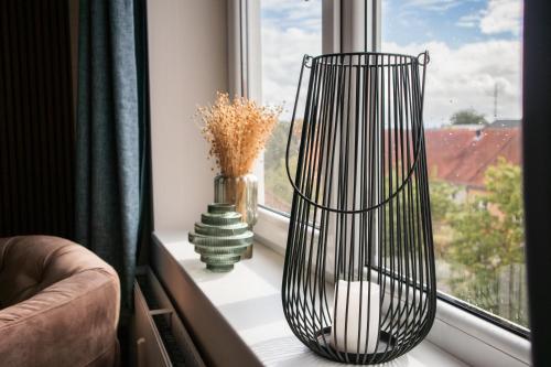 a window sill with two vases and a vase at Hotel Phønix Hjørring in Hjørring
