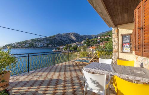 a balcony with a table and chairs and a view of the water at Gorgeous Apartment In Sveti Juraj in Sveti Juraj