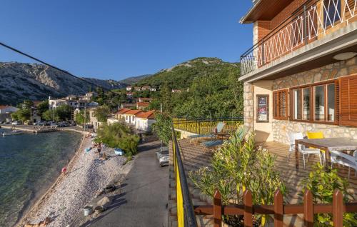 a balcony of a house with a view of a beach at Gorgeous Apartment In Sveti Juraj in Sveti Juraj