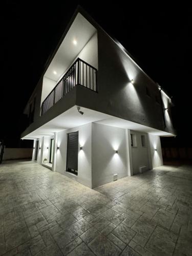 a building with a staircase on top of it at night at Villa Papa-Berat in Berat