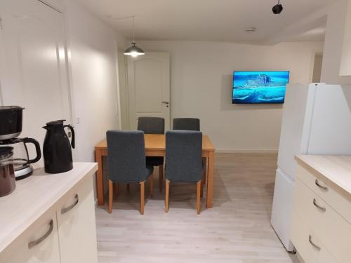 a kitchen with a table and chairs in a room at Fjeldgaard in Odense