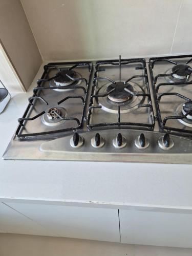 a stove top oven sitting on top of a counter at My Cosy Place Rabat - Cosy Home Wifak Temara in Temara