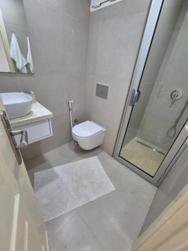 a bathroom with a shower and a toilet and a sink at My Cosy Place Rabat - Cosy Home Wifak Temara in Temara