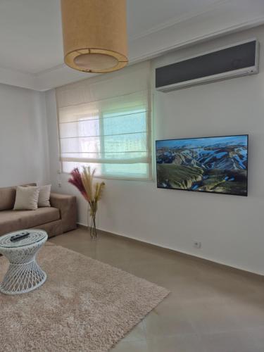 a living room with a couch and a table at My Cosy Place Rabat - Cosy Home Wifak Temara in Temara
