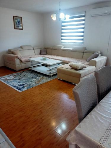a living room with a couch and a coffee table at Apartment In The Nature in Ilidza