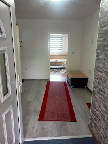 an empty room with a red rug on the floor at Apartment In The Nature in Ilidza