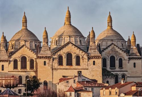 a large building with domes on top of it at Maison en pierre piscine clim in Varennes