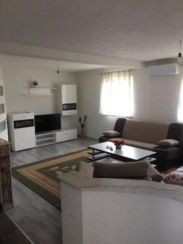 a living room with a couch and a table at Apartment In The Nature in Ilidza