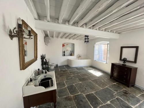 a bathroom with a tub and a sink and a mirror at Villa Iren in Parakopí