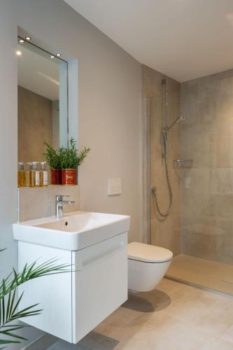 a bathroom with a sink and a toilet and a shower at The Art Loft in Kingsbridge