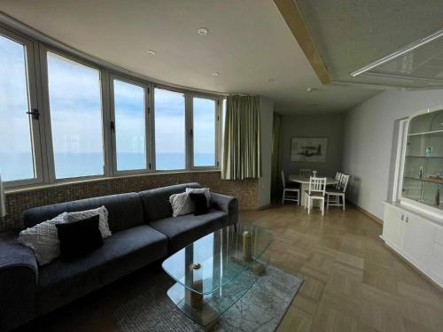 a living room with a couch and a table at Royal on the Sea in Netanya