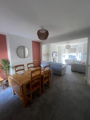 a living room with a table and chairs and a couch at Stylish House Near Beach in Pakefield