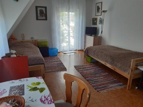 a living room with two beds and a table and a dining room at Ferienwohnung Kastanie in Zirndorf