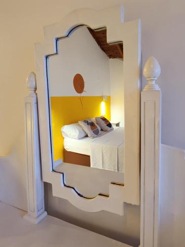 a bedroom with a mirror on the wall at Yedi Butik Hotel in Kemer