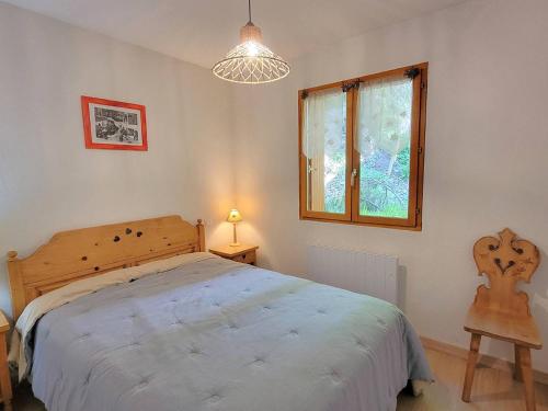 une chambre avec un grand lit et une fenêtre dans l'établissement Duplex 8/9 pers avec terrasse Sud, proche pistes, Wi-Fi, animaux OK, parking + options - FR-1-393-92, à Saint-Michel-de-Chaillol