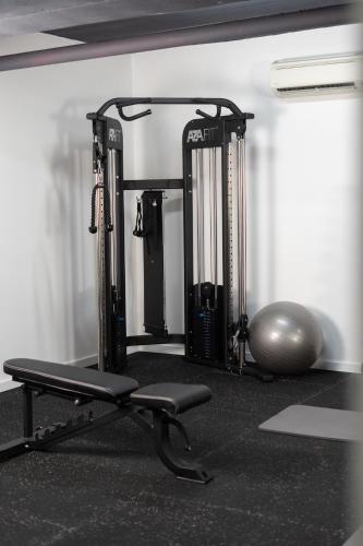 a gym with two tread machines and a exercise ball at Hotel Cristal Setúbal in Setúbal