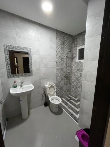 a bathroom with a sink and a toilet and a shower at Nador New in Nador