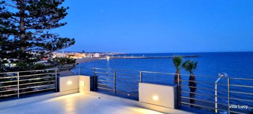 a view of the ocean from a house at Luxury villa Lucy with pool on front of beach of Donnalucata in Donnalucata