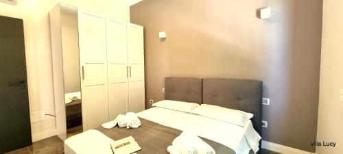 a bedroom with a bed with two towels on it at Luxury villa Lucy with pool on front of beach of Donnalucata in Donnalucata