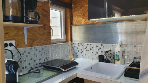 a kitchen with a sink and a counter top at Studio du 44 in Poitiers