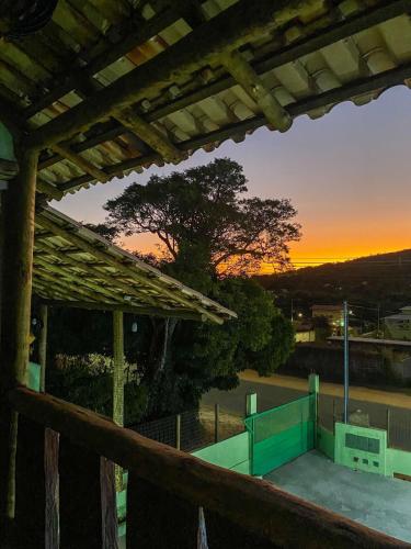 a view of a sunset from a wooden deck at Pousada Cardeal Mota in Serra do Cipo
