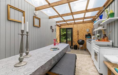 a kitchen with a table with candles on it at 2 Bedroom Nice Home In Rønde in Rønde