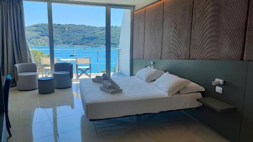 a bedroom with a bed and a view of the water at Cristallo Park Hotel in Portovenere