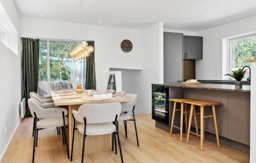 a kitchen and dining room with a table and chairs at 4 Bedroom Beach Front Home In Børkop in Børkop
