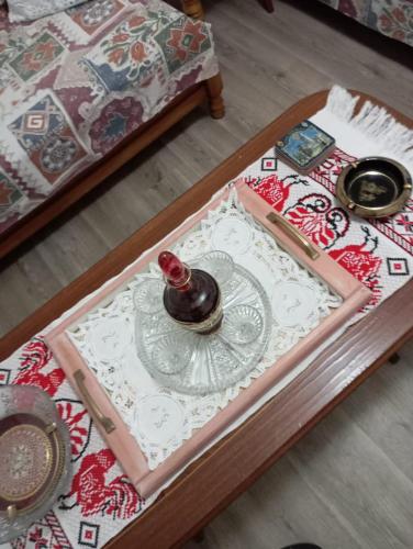a coffee table with a bottle on top of it at Irini's house in Panayia