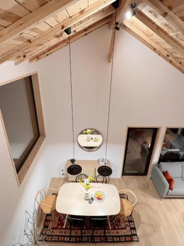 a dining room with a table and chairs at Forestia - Modern cabin with hot tub and sauna in Dealu Negru
