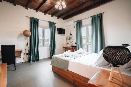 a bedroom with a bed with green curtains and a chair at Villa Di Leon - Uniquely Designed Villa with Pool in a Picturesque Village near Famous Porto Limnionas, Offering Exceptional Hospitality By Villa Mana Gers in Agios Leon