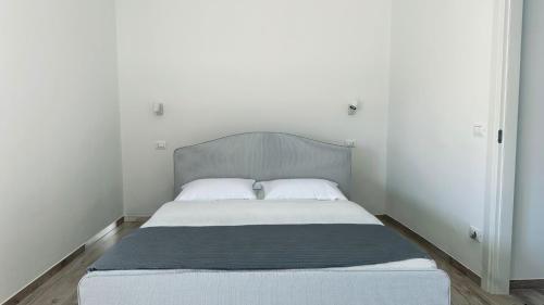 1 cama con 2 almohadas en un dormitorio blanco en P022 - Porto Recanati, nuovissimo bilocale fronte mare, en Porto Recanati