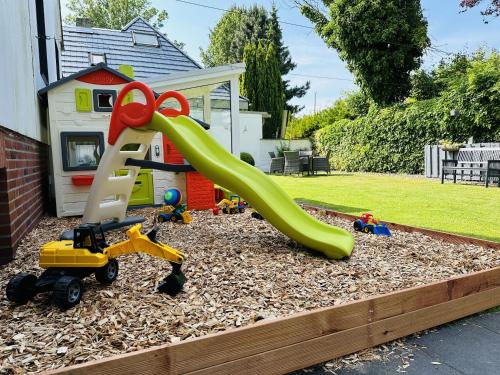 a playground with a slide and toys in a yard at Gästehaus Bremer in Cuxhaven