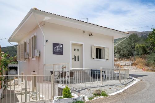 a small white building with a fence around it at El Padre Residence in Sívros