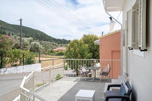 a view from the balcony of a house with a table and chairs at El Padre Residence in Sívros