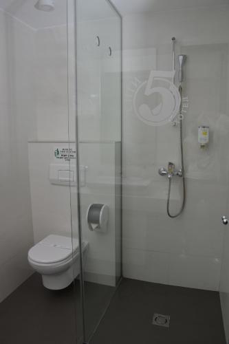 a bathroom with a toilet and a glass shower at Luxury Skopje Apartments in Skopje