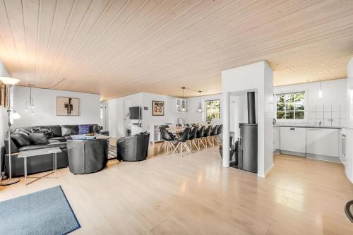 a living room with a couch and a table at Nice Pool House For 12 Persons - 1021 in Ringkøbing