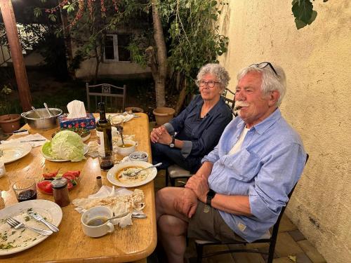 two older men sitting at a table with food at Popock City Center in Yerevan