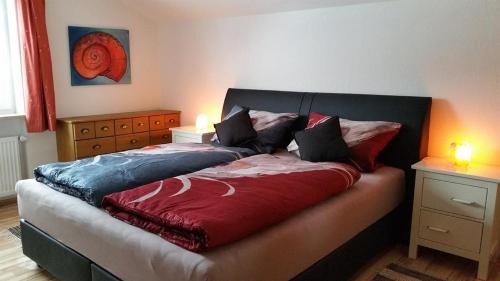 a bed in a bedroom with two lamps on a table at Ferienwohnung Sonnenblume in Halblech