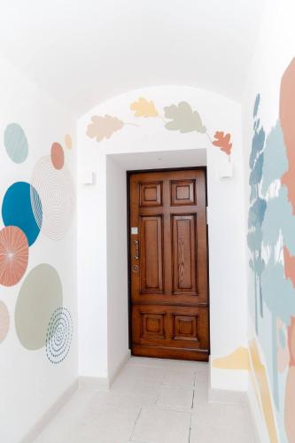 a wooden door in a room with a wall at InLoco - Natural Experience in Acqualagna