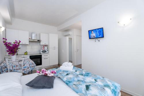 a living room with a couch and a table with flowers on it at Station's Apartments Bergamo in Bergamo