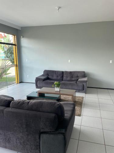 a living room with two couches and a coffee table at Pousada Alvorada in Ubajara